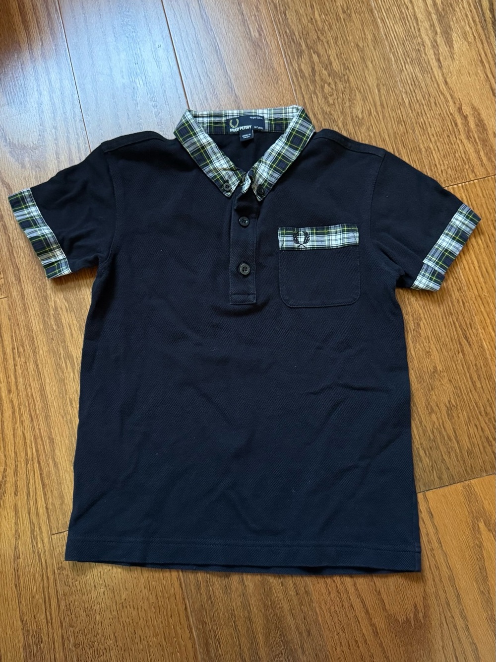 Fred Perry black polo shirt with plaid collar and sleeve cuffs, size 6-7 years